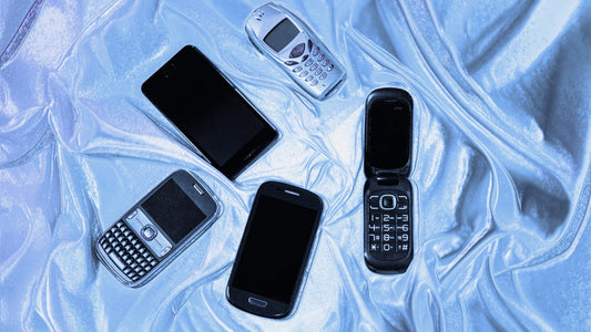 an image of 5 different phones, 2 touch screen, 1 flip phone and 2 button phones. They. are laying on a background of blue and silver swirls.