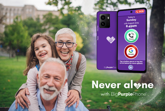 family with grandparents smiling and happy with a BigPurplePhone next to them and text below reads 'never alone with big purple phone'.