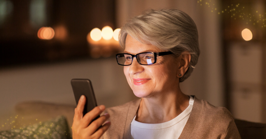 woman looking at her BigPurplePhone, happy, glowing in her face with sparkles.